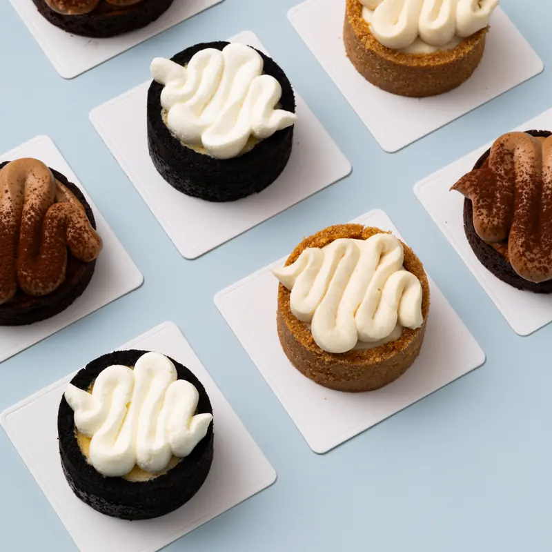 Chocolate and cream tarts on a pale blue table