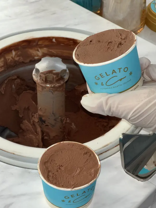 Chocolate gelato being scooped into a Gelato & Co cup