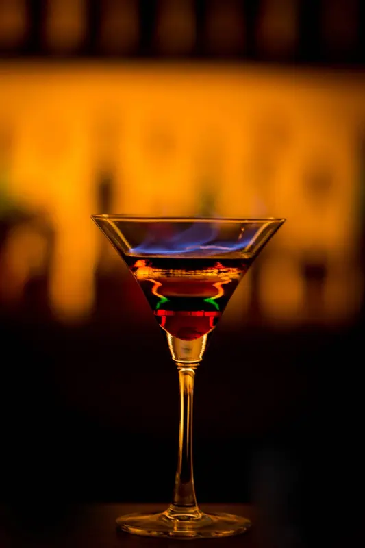A cocktail glowing on the bar at Nest